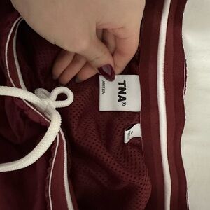 TNA tracksuit pants in cordovan